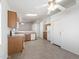 Open kitchen with white appliances, wooden cabinets, tile floor, and views of the breakfast area at 8549 E Carol Ave, Mesa, AZ 85208