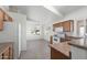 Bright kitchen with white appliances, wood cabinetry, tile flooring, and eat-in area with natural light at 8549 E Carol Ave, Mesa, AZ 85208