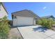 One-story house with a white garage door and desert landscaping at 8637 N 168Th Dr, Waddell, AZ 85355