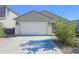 One-story house with a white garage door and small shrubs at 8637 N 168Th Dr, Waddell, AZ 85355