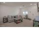 Living room with grey sofa and entryway at 8637 N 168Th Dr, Waddell, AZ 85355