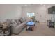 Bright living room with gray sofa and coffee table at 8637 N 168Th Dr, Waddell, AZ 85355