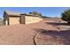 Large backyard with gravel and curved landscaping at 9283 W Rafael Dr, Arizona City, AZ 85123