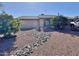 Front yard with gravel landscaping and mature trees at 9283 W Rafael Dr, Arizona City, AZ 85123