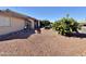 Side view of the house with rock landscaping at 9283 W Rafael Dr, Arizona City, AZ 85123