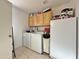 Laundry room with washer, dryer, cabinets, and extra fridge at 9283 W Rafael Dr, Arizona City, AZ 85123