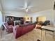 Living room with vaulted ceilings, tiled floors, and a view to dining area at 9283 W Rafael Dr, Arizona City, AZ 85123