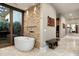 Bathroom with freestanding tub and sliding glass doors to patio at 9374 E Andora Hills Dr, Scottsdale, AZ 85262