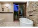 Bathroom with freestanding tub and sliding glass doors to patio at 9374 E Andora Hills Dr, Scottsdale, AZ 85262