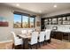 Elegant dining room featuring a large table, built-in cabinetry, and scenic views at 9374 E Andora Hills Dr, Scottsdale, AZ 85262