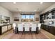 Bright dining room with a large table, built-in cabinetry, and natural light at 9374 E Andora Hills Dr, Scottsdale, AZ 85262