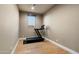 Dedicated home gym space with a modern treadmill and wood flooring at 9374 E Andora Hills Dr, Scottsdale, AZ 85262