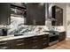 Modern kitchen with dark cabinetry and marble countertops at 9374 E Andora Hills Dr, Scottsdale, AZ 85262