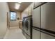 Bright laundry room, featuring modern washer, dryer, and ample cabinetry at 9374 E Andora Hills Dr, Scottsdale, AZ 85262