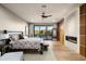 Main bedroom with king bed, fireplace, and access to balcony at 9374 E Andora Hills Dr, Scottsdale, AZ 85262