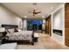 Main bedroom with king bed, fireplace, and access to balcony at 9374 E Andora Hills Dr, Scottsdale, AZ 85262