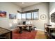 Home office featuring a large desk, abundant natural light, and built-in shelving at 9374 E Andora Hills Dr, Scottsdale, AZ 85262