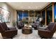 Sitting area with four leather armchairs and a large window showcasing a view at 9374 E Andora Hills Dr, Scottsdale, AZ 85262