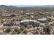 Aerial view of a large home, pool, and tennis court in a desert community at 9570 E Via Montoya Dr, Scottsdale, AZ 85255