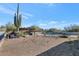 Landscaped backyard with a pool, pergola, and cactus plants at 9570 E Via Montoya Dr, Scottsdale, AZ 85255