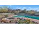 Inviting pool and spa surrounded by desert landscaping at 9570 E Via Montoya Dr, Scottsdale, AZ 85255