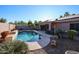 Enjoy this large, kidney-shaped pool with a waterfall feature in a sunny backyard setting at 9621 N 94Th Dr, Peoria, AZ 85345