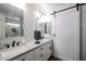 Modern bathroom with double vanity and herringbone tile at 9621 N 94Th Dr, Peoria, AZ 85345