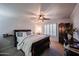 Comfortable bedroom with ceiling fan and wood furniture at 9621 N 94Th Dr, Peoria, AZ 85345