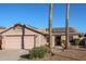 Single-story home with solar panels, two-car garage, and desert landscaping at 9621 N 94Th Dr, Peoria, AZ 85345