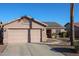 Two-car garage and front entry of a well-maintained single-story home at 9621 N 94Th Dr, Peoria, AZ 85345