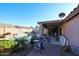 Covered patio with seating overlooking a refreshing pool and landscaped backyard at 9621 N 94Th Dr, Peoria, AZ 85345