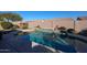 Stunning pool with a cascading water feature and ample surrounding space at 9621 N 94Th Dr, Peoria, AZ 85345