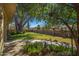 Mature trees and walkway leading to house at 101 S Mesquite St, Wickenburg, AZ 85390