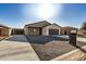 Modern two-car garage home with neutral exterior at 10671 W Arivaca Dr, Arizona City, AZ 85123