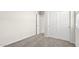 Secondary bedroom with neutral carpeting and double-door closet at 109 S Collier Ln, Casa Grande, AZ 85122