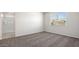 Spacious bedroom with neutral carpeting and large window at 109 S Collier Ln, Casa Grande, AZ 85122