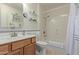 Bathroom with tub, shower, and glass shelves at 13635 N Emberwood Dr, Sun City, AZ 85351