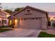 Tan one-story house with a two-car garage and well-manicured lawn at 1501 W Blue Ridge Way, Chandler, AZ 85248