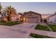 Tan one-story house with a two-car garage and well-manicured lawn at 1501 W Blue Ridge Way, Chandler, AZ 85248