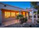 Backyard patio with pergola, lighting, and landscaping at dusk at 15583 W Big Sky Dr, Surprise, AZ 85374