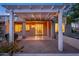Covered patio with pergola, lighting, and paver stones at dusk at 15583 W Big Sky Dr, Surprise, AZ 85374