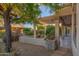 Spacious backyard patio with pergola, stone accents, and desert landscaping at 15583 W Big Sky Dr, Surprise, AZ 85374