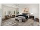 Bright bedroom with wood floors, bay window, and seating area at 15583 W Big Sky Dr, Surprise, AZ 85374