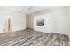 Bedroom with wood floors, built-in entertainment center and en-suite bathroom at 15583 W Big Sky Dr, Surprise, AZ 85374