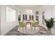 Bright breakfast nook with wood-look flooring and plantation shutters at 15583 W Big Sky Dr, Surprise, AZ 85374