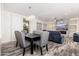 Elegant dining room with a table and gray upholstered chairs at 15583 W Big Sky Dr, Surprise, AZ 85374