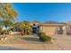 Single-story home with a two-car garage, desert landscaping, and stone accents at 15583 W Big Sky Dr, Surprise, AZ 85374