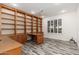 Spacious home office with built-in shelving and wood desk at 15583 W Big Sky Dr, Surprise, AZ 85374