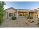 Back exterior view of the house with a covered patio area at 15583 W Big Sky Dr, Surprise, AZ 85374