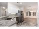 Modern kitchen with granite countertops, stainless steel appliances, and white cabinets at 15583 W Big Sky Dr, Surprise, AZ 85374